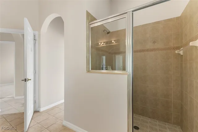 a bathroom with a glass shower door