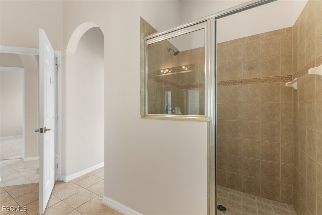 3520 Lansing Loop, Unit 203 Estero, FL 33928 - Photo 33 of 34 a bathroom with a glass shower door