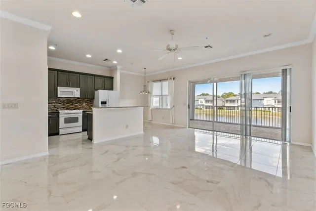 a view of a kitchen with refrigerator and microwave
