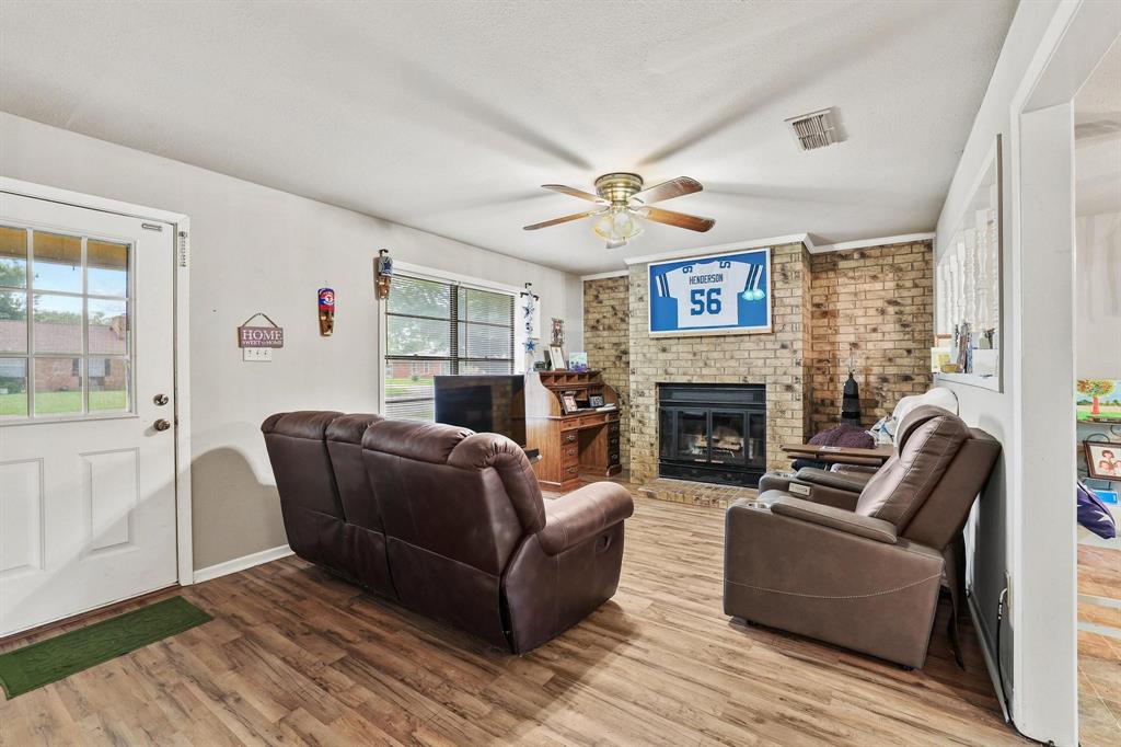606 Hunter Street Bonham, TX 75418 - Photo 3 of 15 a living room with furniture and a fireplace