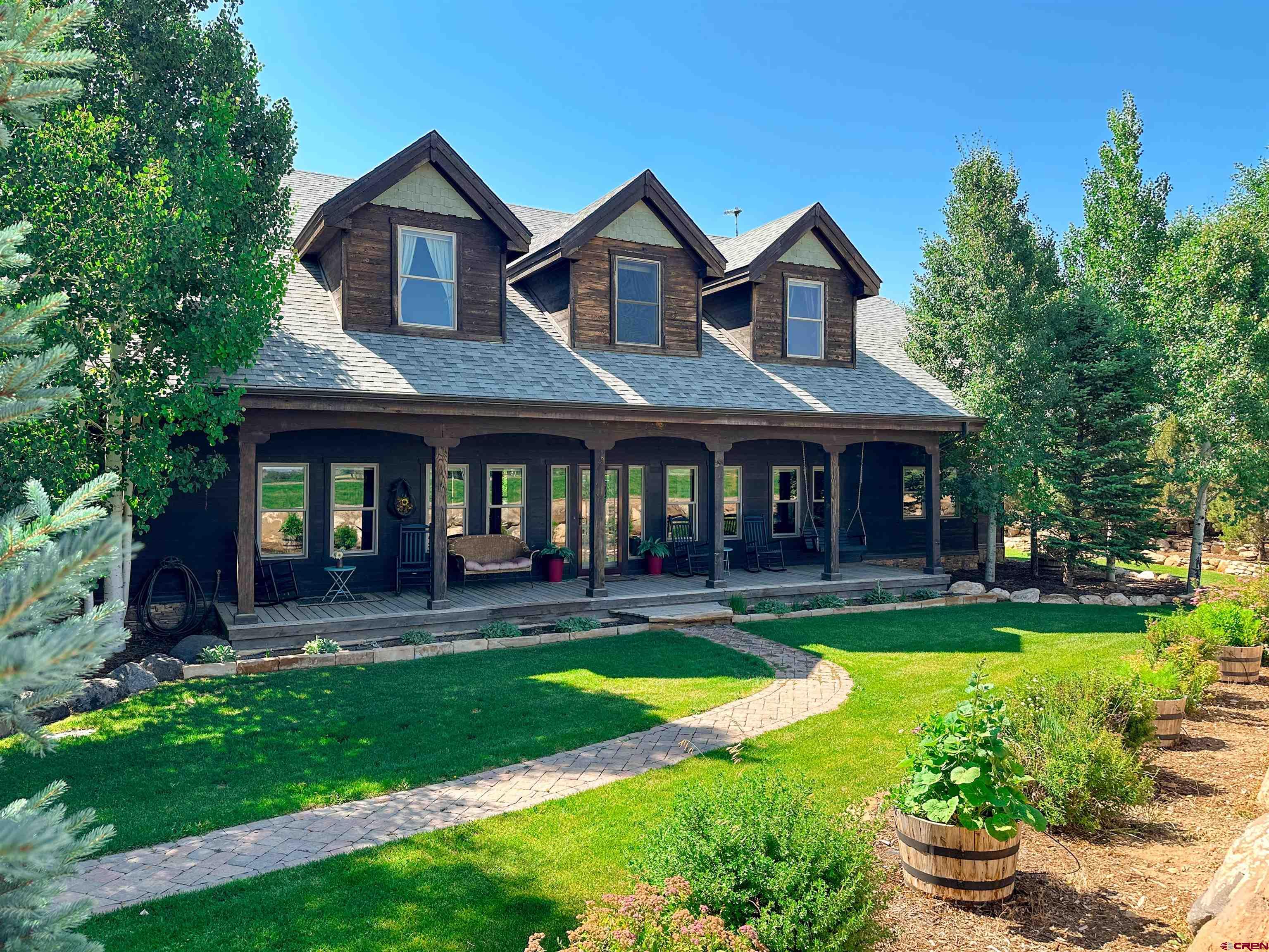 a front view of a house with yard and green space