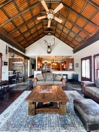 a living room with furniture a ceiling fan with a rug
