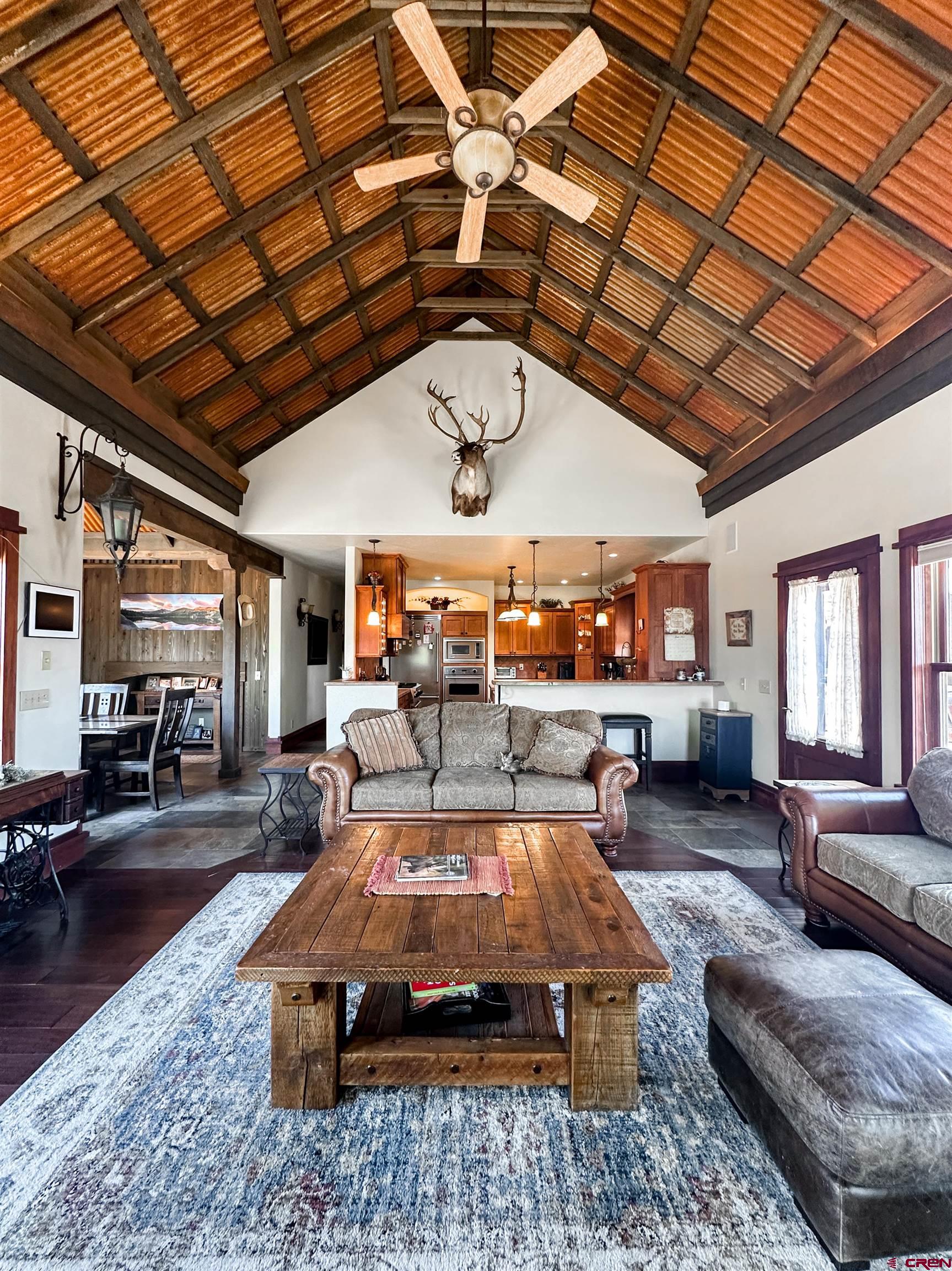 7276 5550th Road Olathe, CO 81425 - Photo 13 of 45 a living room with furniture a ceiling fan with a rug