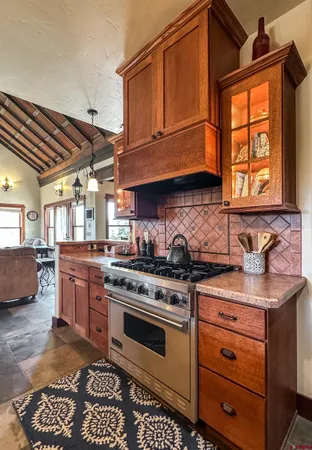 a kitchen with stainless steel appliances granite countertop a stove and cabinets