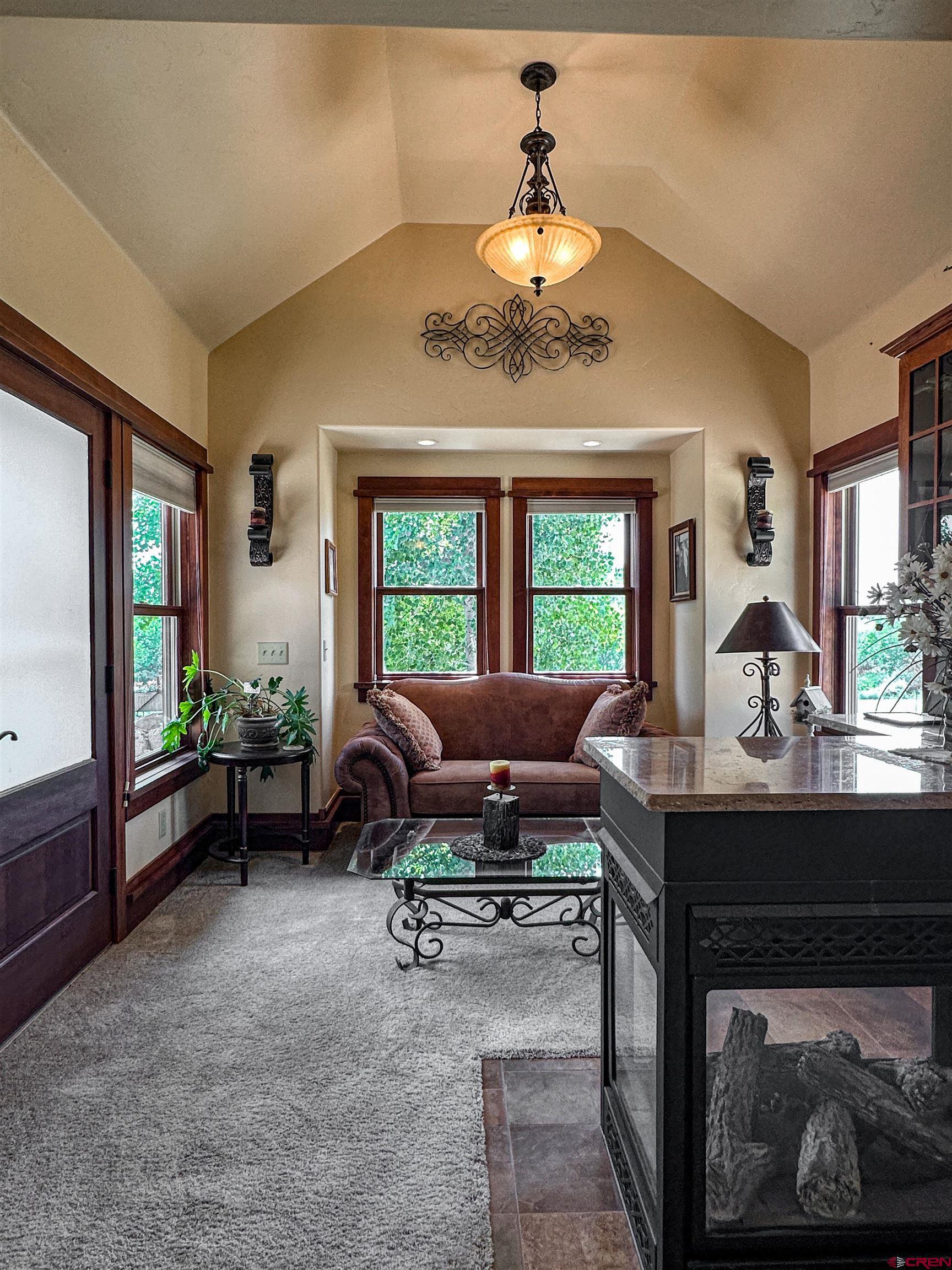 7276 5550th Road Olathe, CO 81425 - Photo 19 of 45 a living room with furniture a chandelier and a window