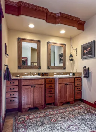 a spacious bathroom with a granite countertop sink and a mirror