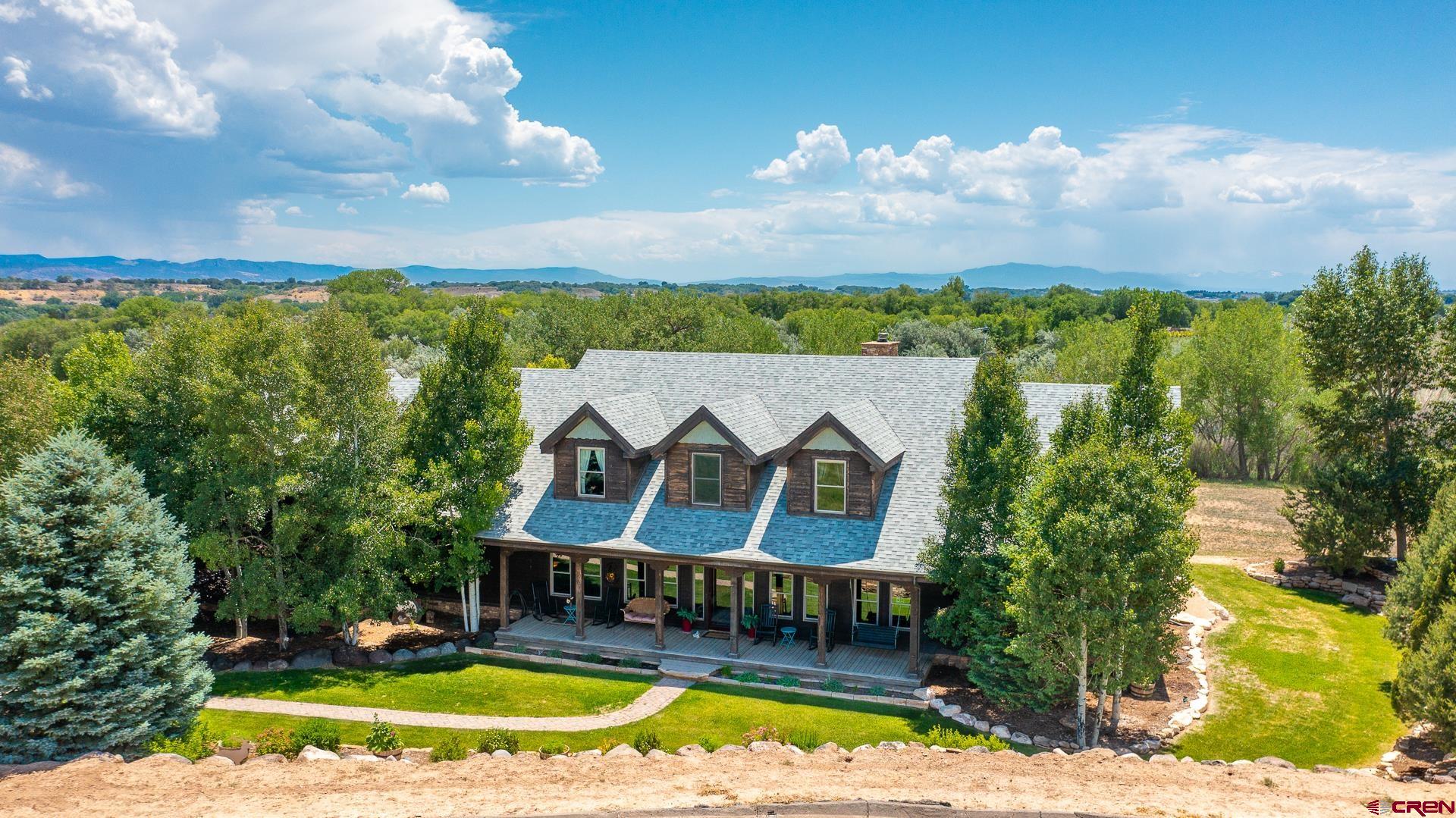 7276 5550th Road Olathe, CO 81425 - Photo 2 of 45 a view of houses with swimming pool and green space