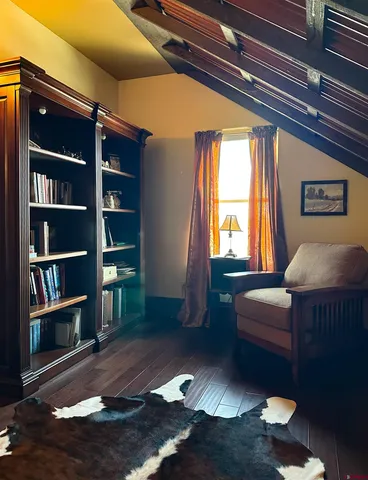 a living room with furniture and a book shelf