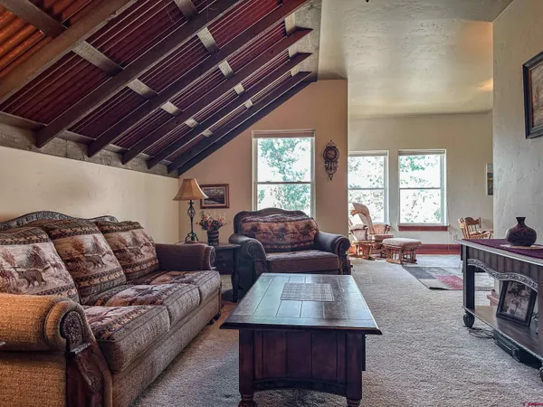a living room with furniture fireplace and a table