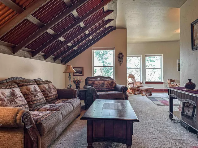 a living room with furniture fireplace and a table