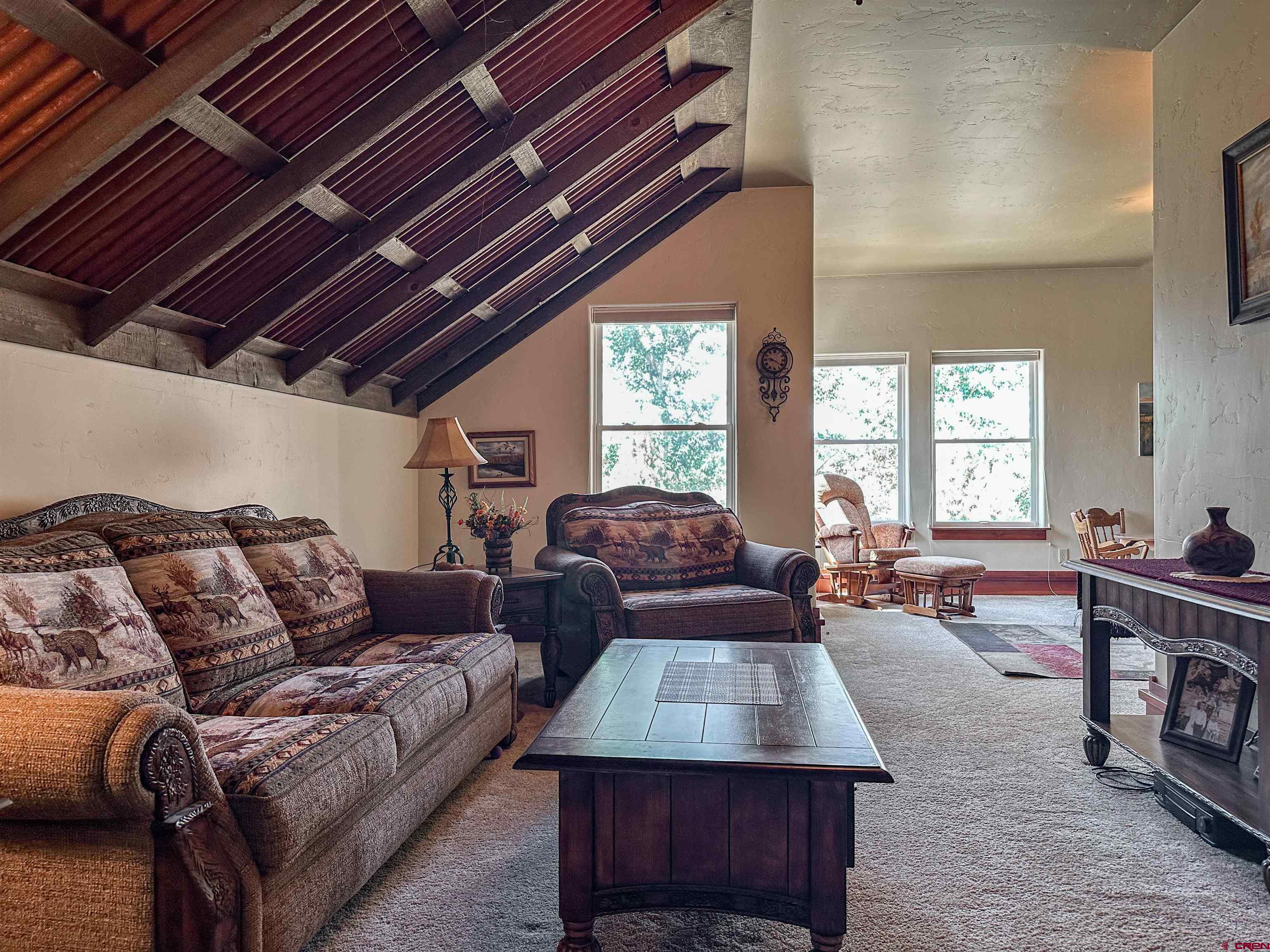 7276 5550th Road Olathe, CO 81425 - Photo 24 of 45 a living room with furniture fireplace and a table