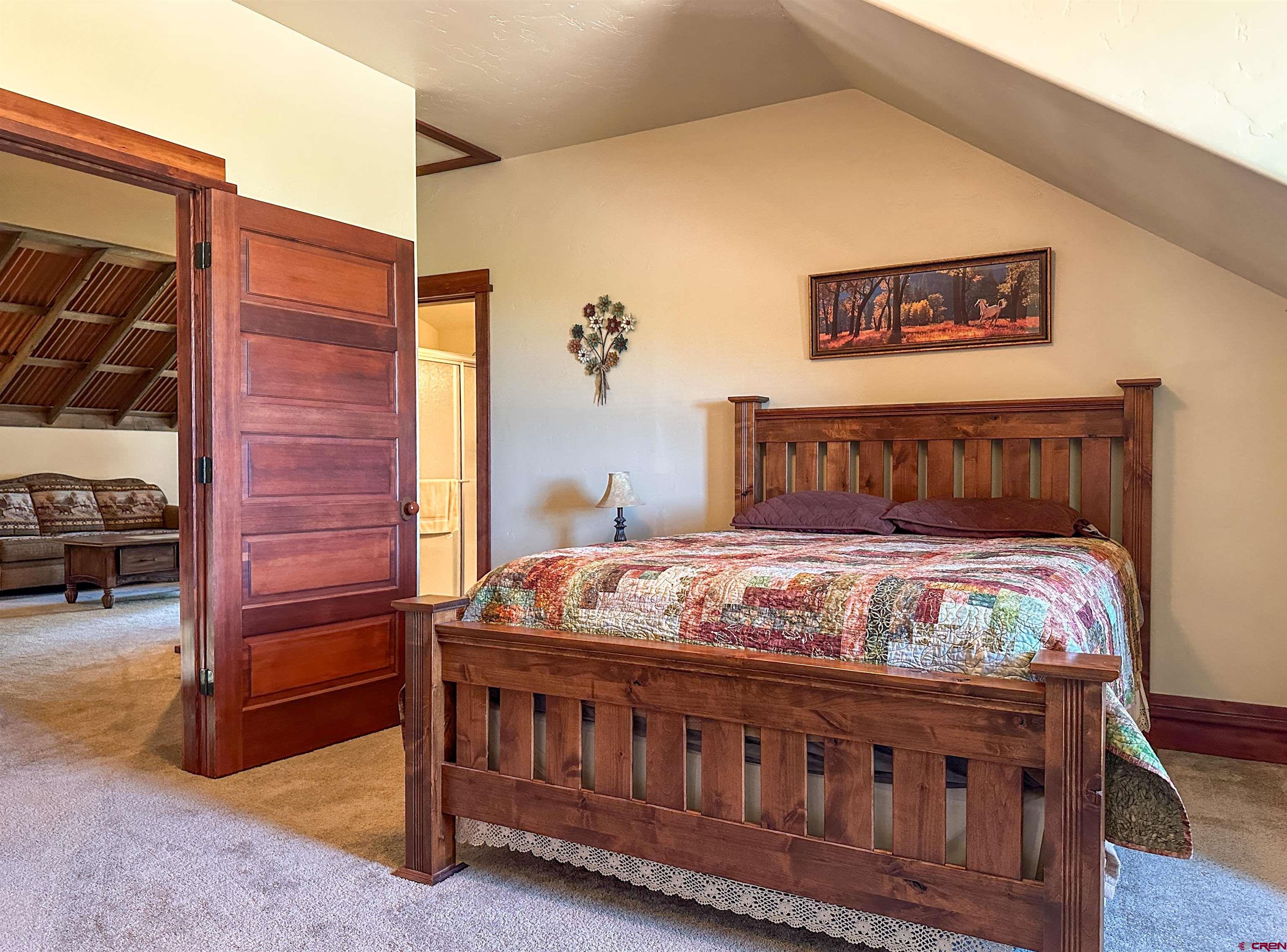 7276 5550th Road Olathe, CO 81425 - Photo 27 of 45 a bedroom with a bed and a view of bathroom