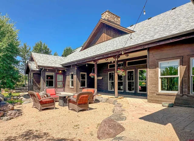 a view of a chairs and table under an umbrella