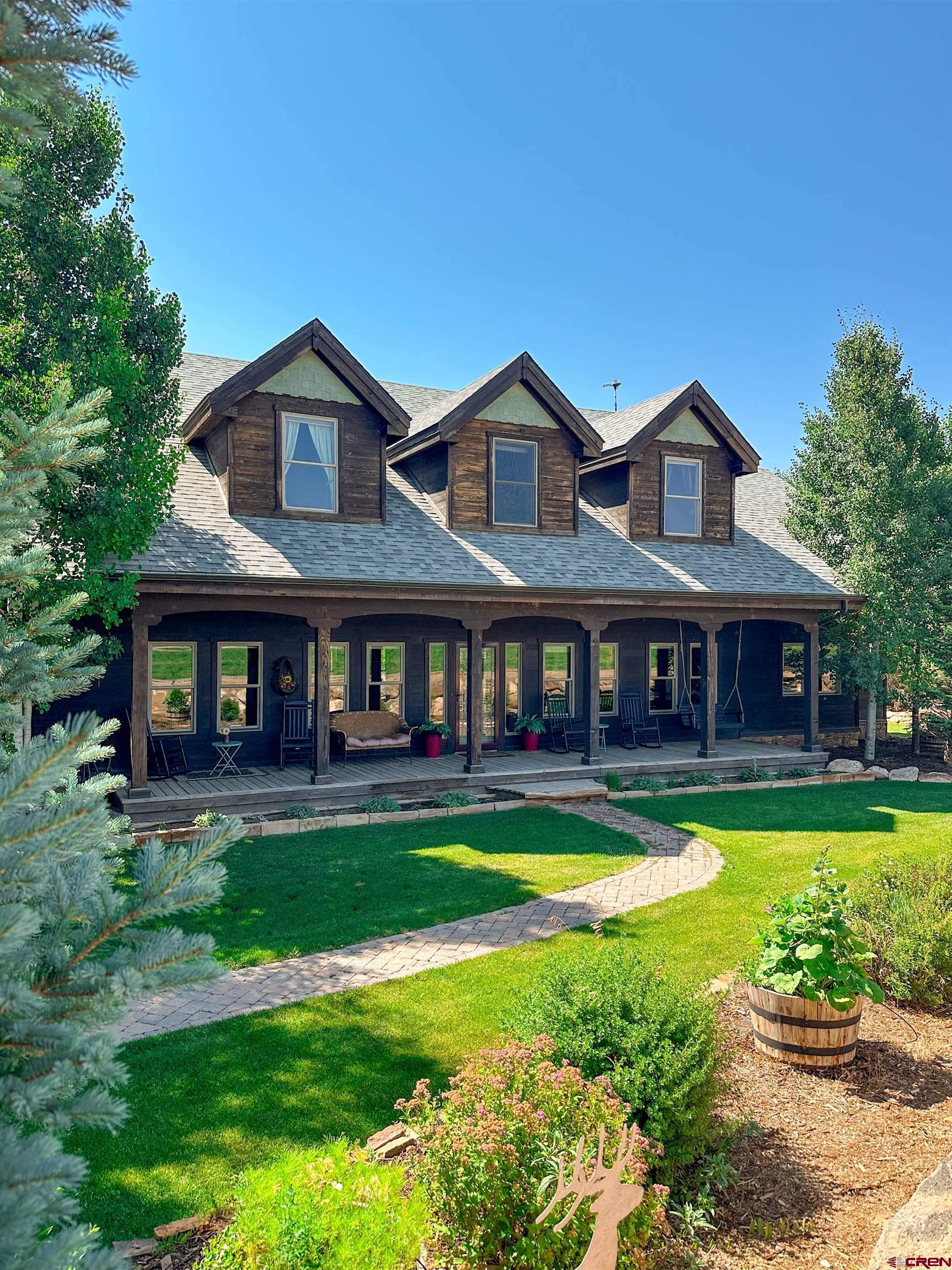 7276 5550th Road Olathe, CO 81425 - Photo 3 of 45 a front view of a house with a yard
