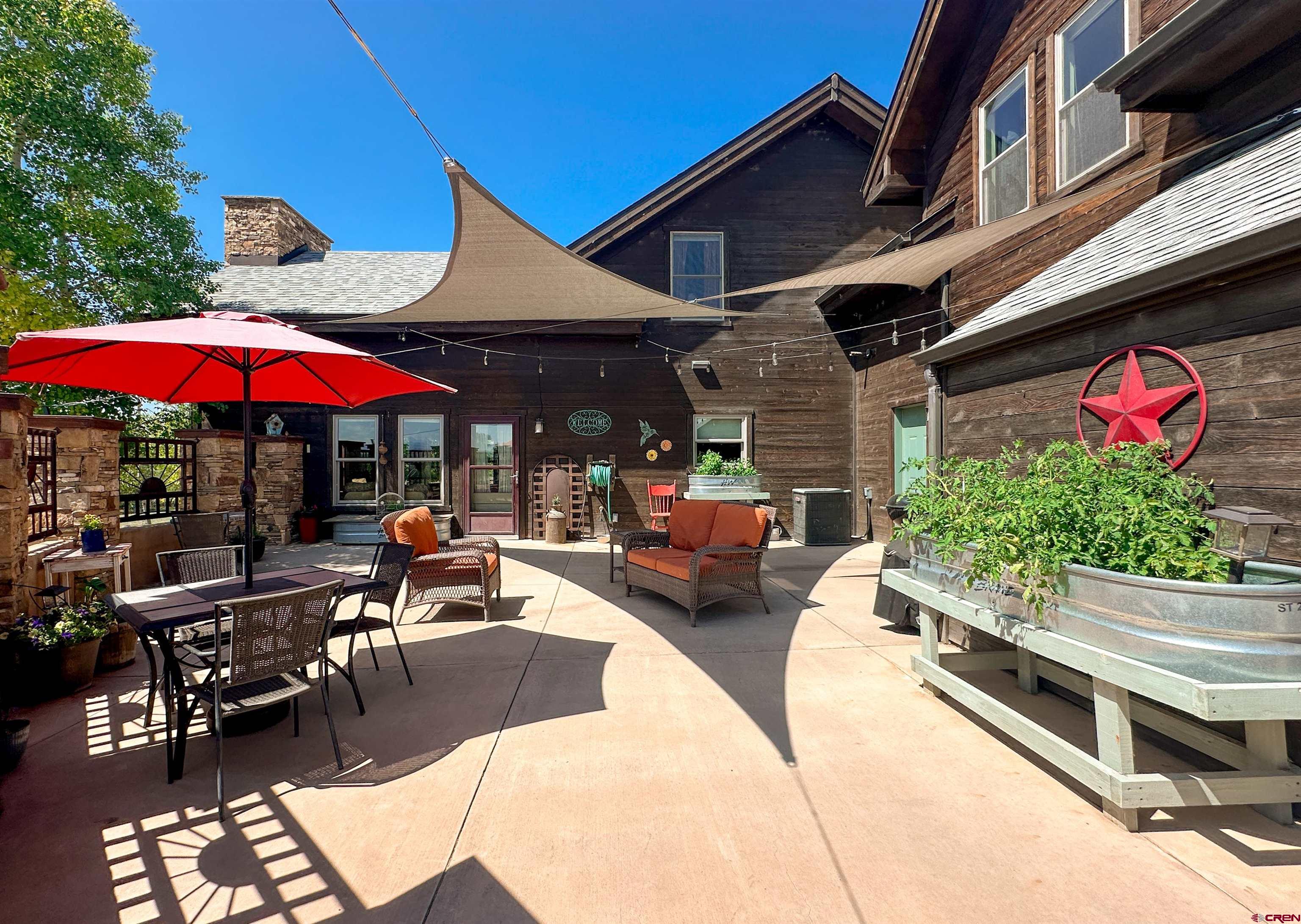 7276 5550th Road Olathe, CO 81425 - Photo 31 of 45 a view of a chairs and table under an umbrella