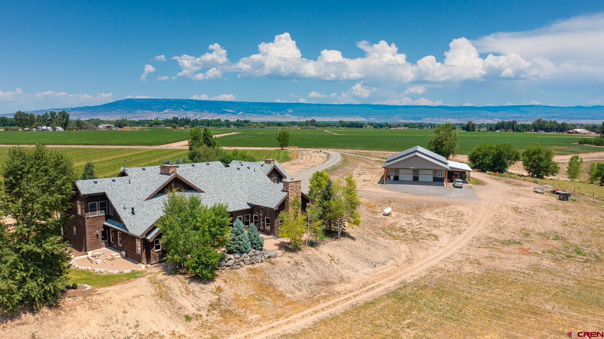 7276 5550th Road Olathe, CO 81425 - Photo 43 of 45 an aerial view of a house with garden space and ocean view