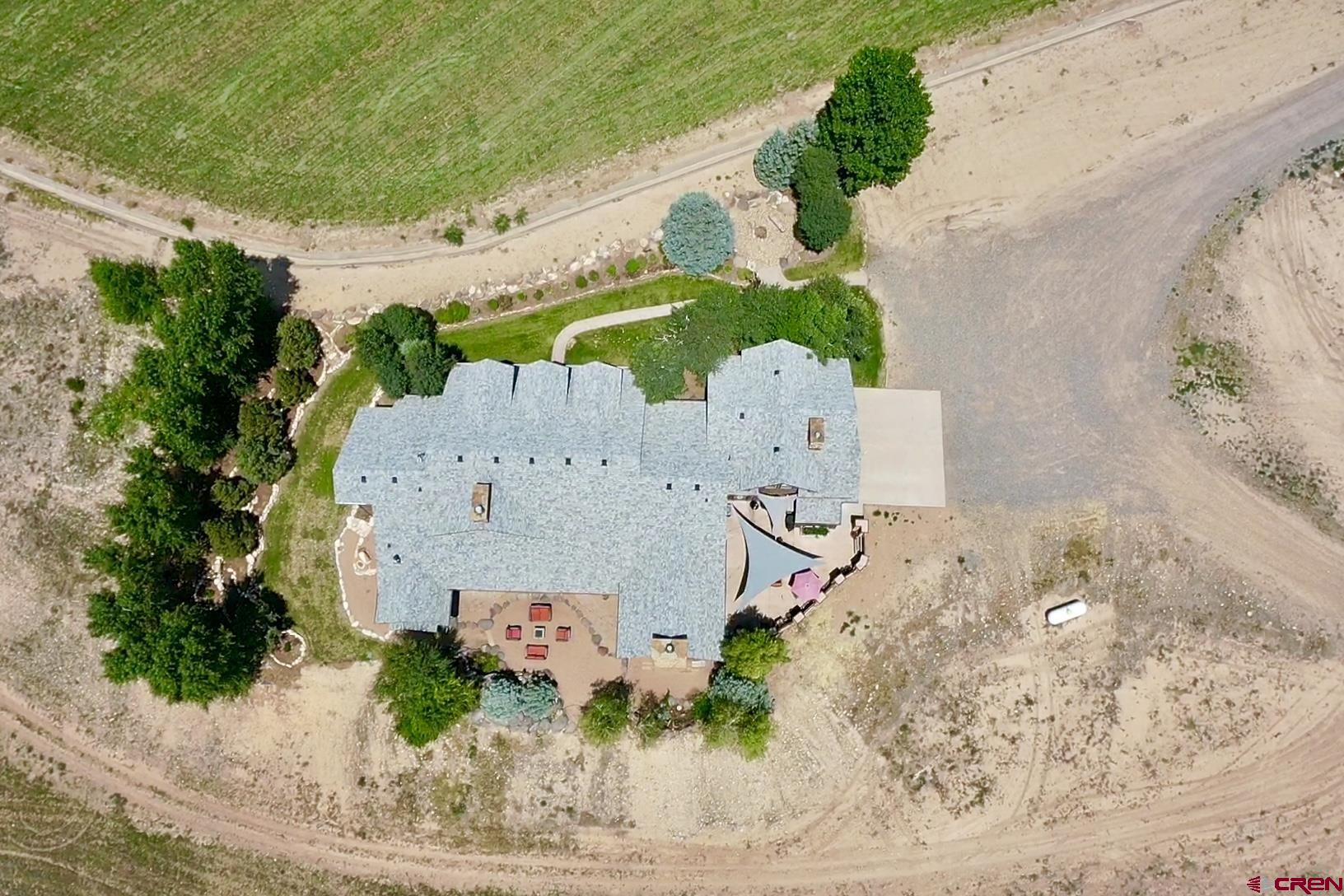 7276 5550th Road Olathe, CO 81425 - Photo 45 of 45 an aerial view of a house with a yard and large trees