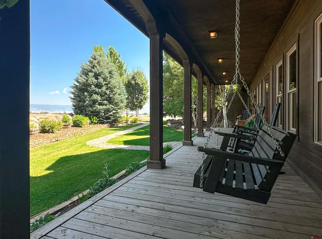 a view of swimming pool with garden and patio