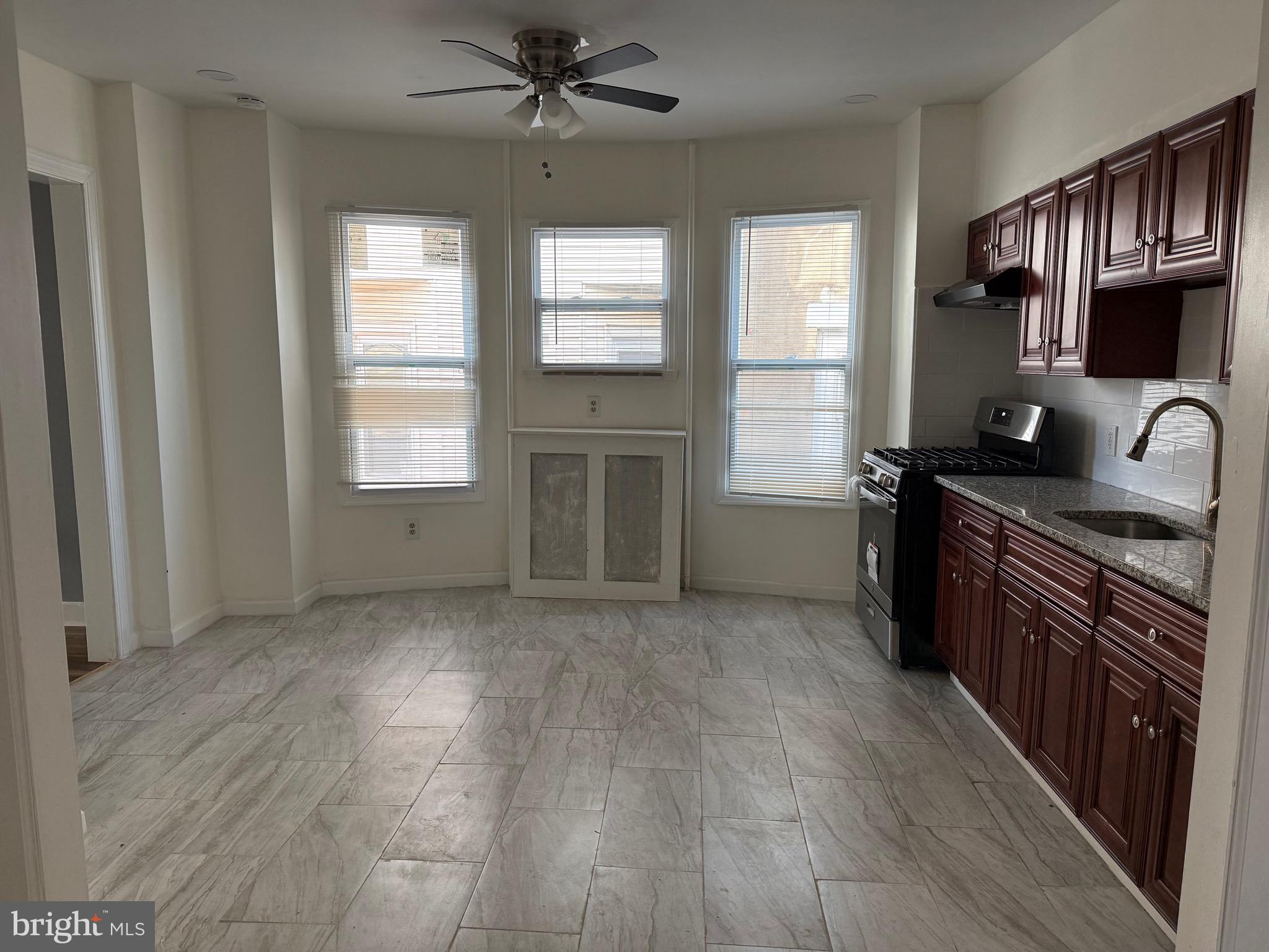 216 South 7th Street Darby, PA 19023 - Photo 23 of 46 a kitchen with stainless steel appliances granite countertop a stove a sink and a refrigerator