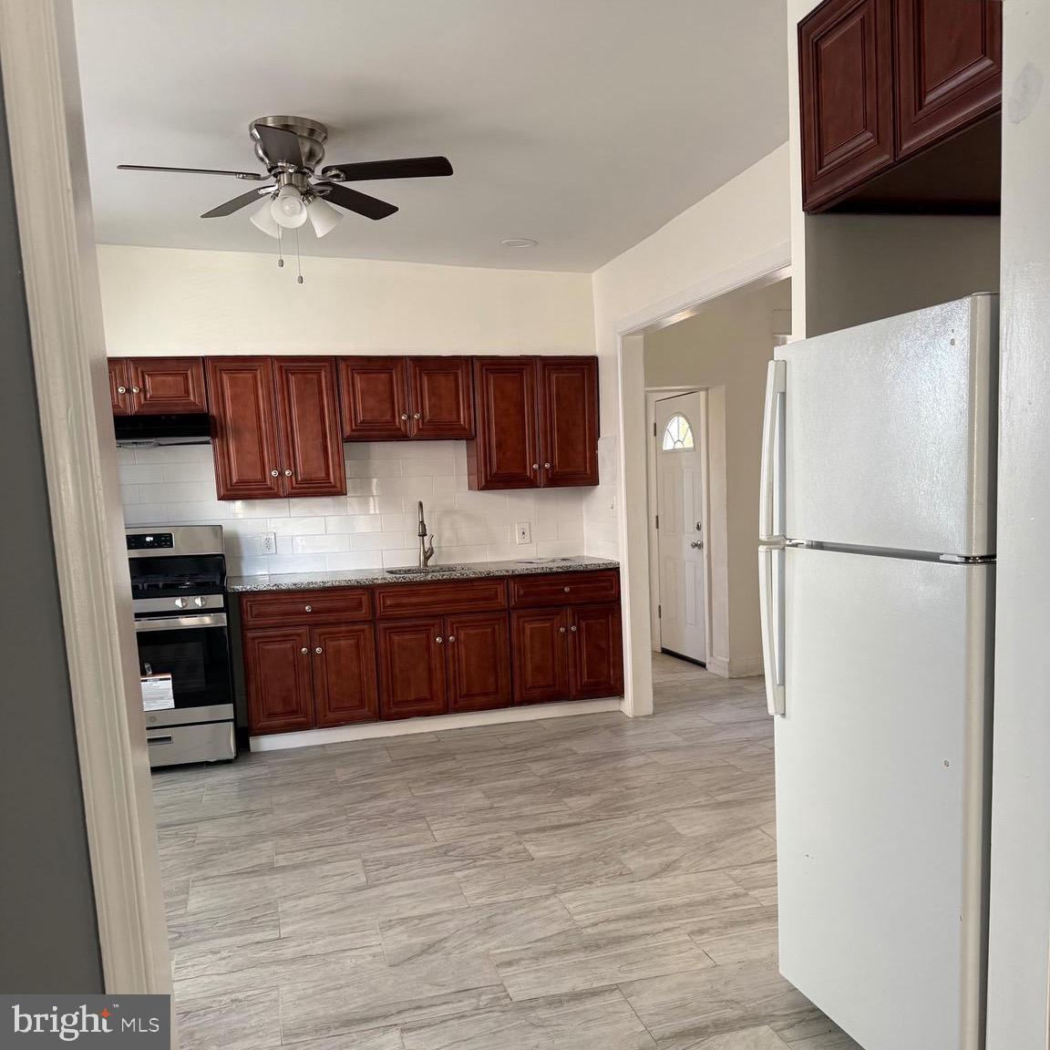 216 South 7th Street Darby, PA 19023 - Photo 26 of 46 a kitchen with stainless steel appliances granite countertop a refrigerator sink and cabinets