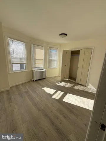 a view of a room with wooden floor and window