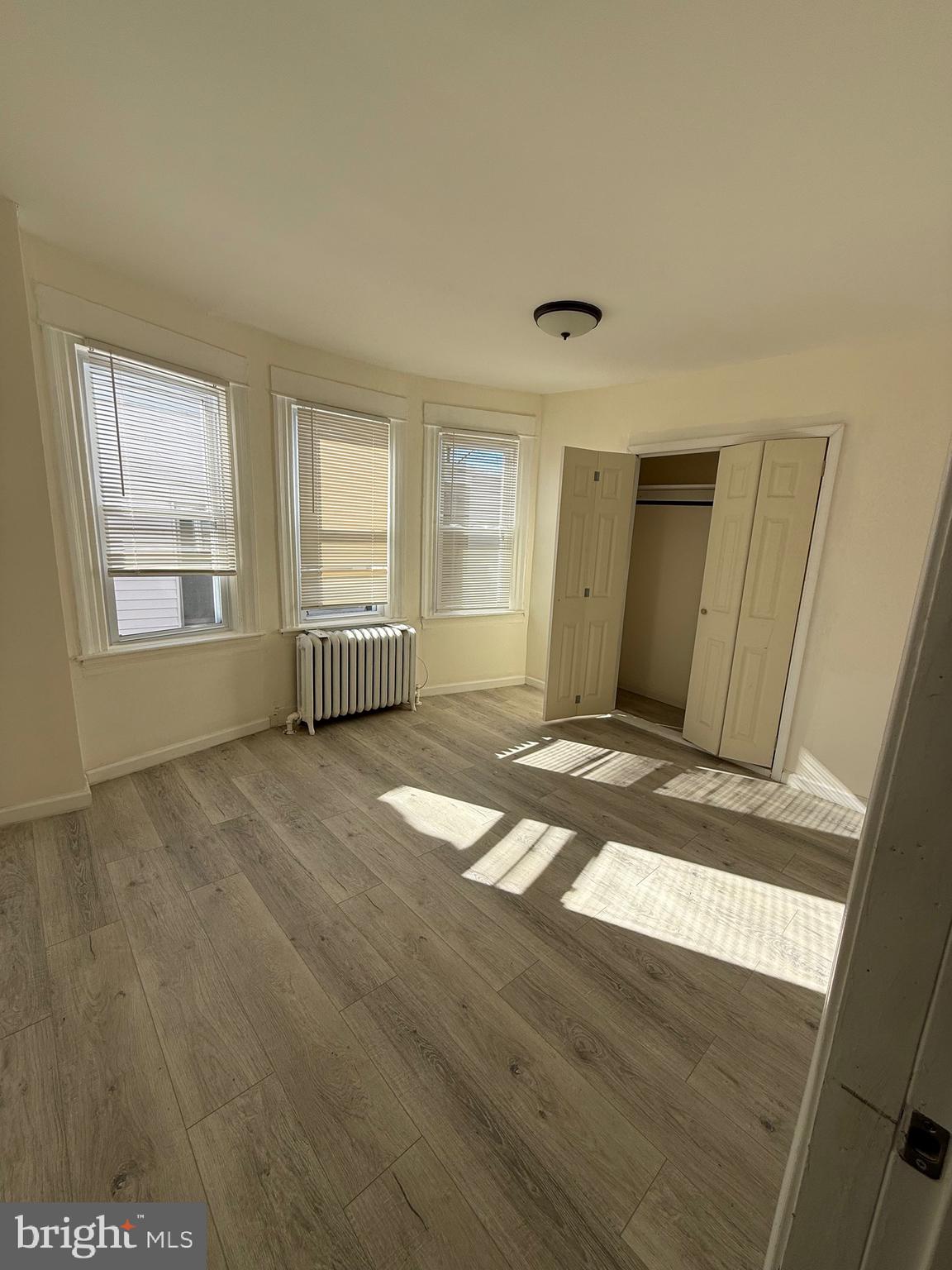 216 South 7th Street Darby, PA 19023 - Photo 37 of 46 an empty room with wooden floor and windows
