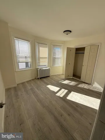 a view of staircase with wooden floor and white walls
