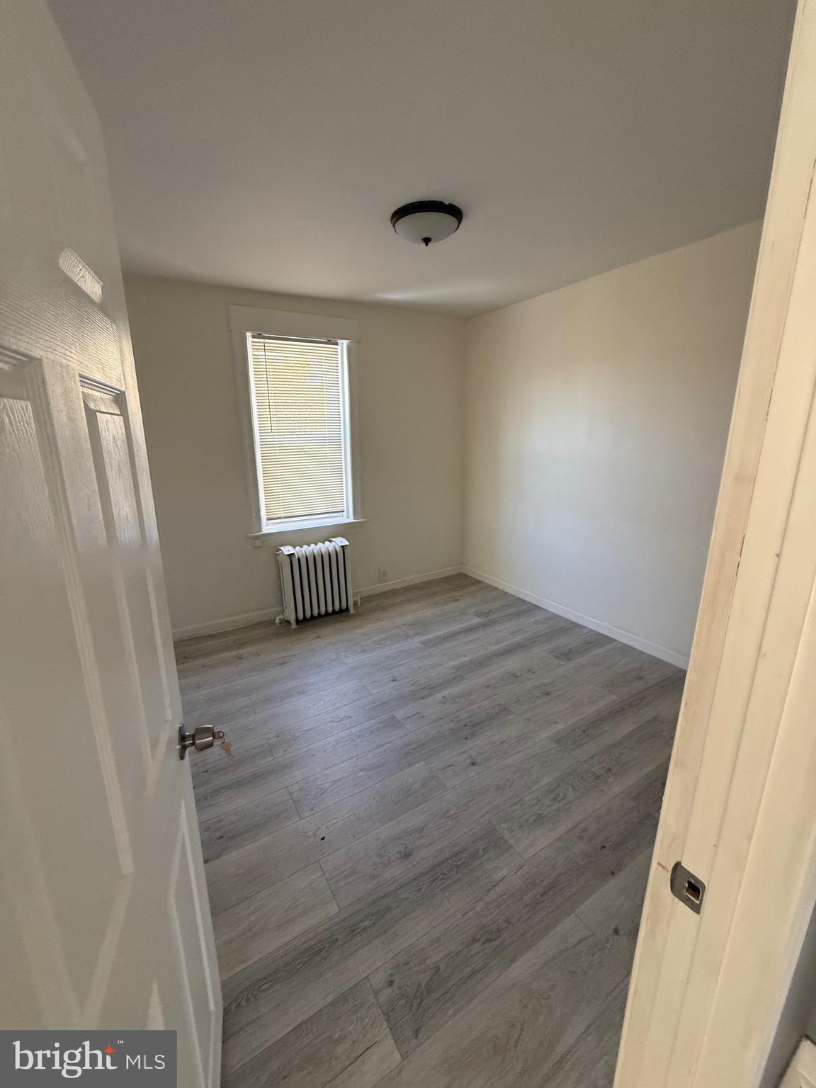 216 South 7th Street Darby, PA 19023 - Photo 46 of 46 an empty room with wooden floor and windows