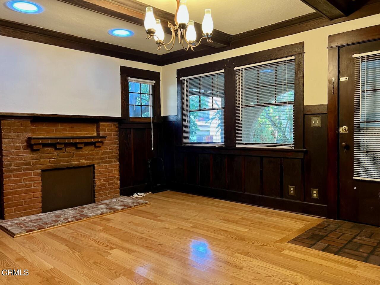 2435 Mohawk Street, Unit 6 Pasadena, CA 91107 - Photo 2 of 5 a bedroom with a bed and a fireplace