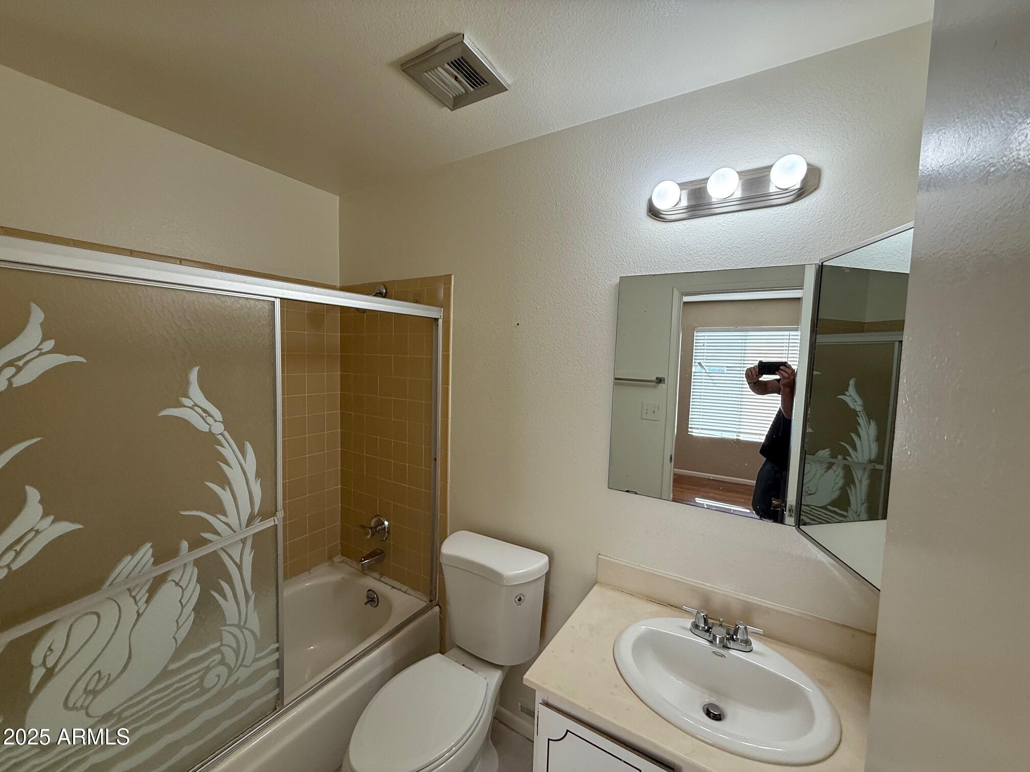 14806 Yerba Buena Way, Unit A Fountain Hills, AZ 85268 - Photo 12 of 16 a bathroom with a toilet sink and mirror