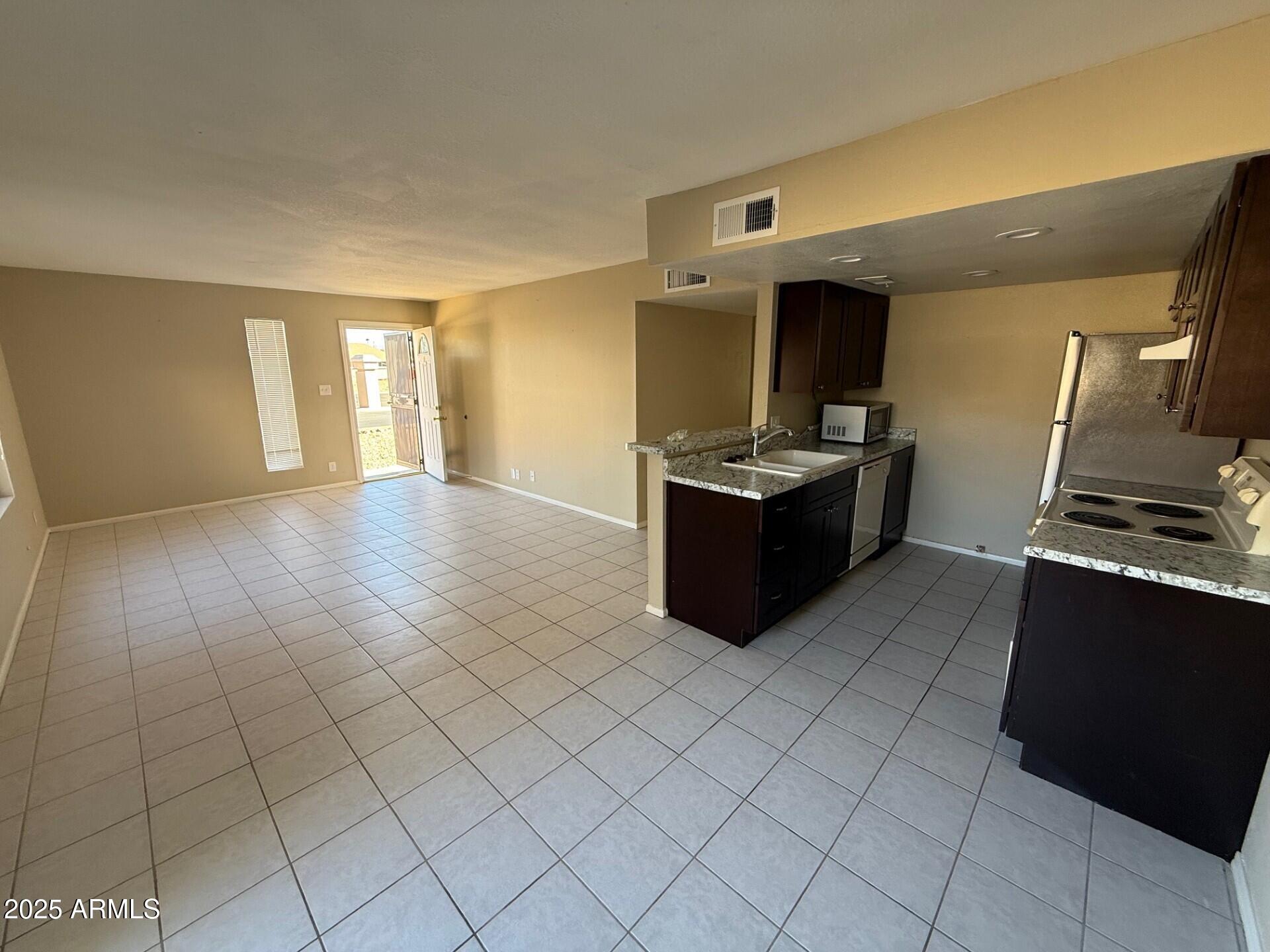 14806 Yerba Buena Way, Unit A Fountain Hills, AZ 85268 - Photo 9 of 16 a kitchen with granite countertop a stove and a refrigerator