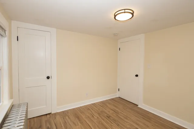 a view of a room with wooden floor