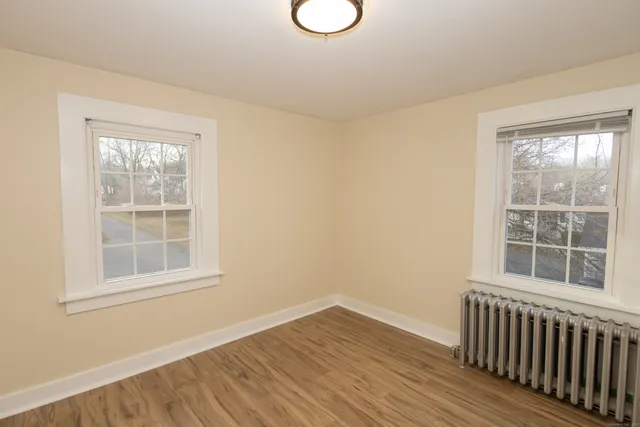 a view of wooden floor and a window in a room