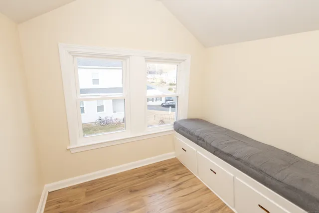 a bathroom with a granite countertop sink and a window