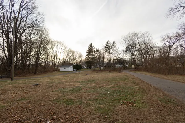 a view of dirt field with trees