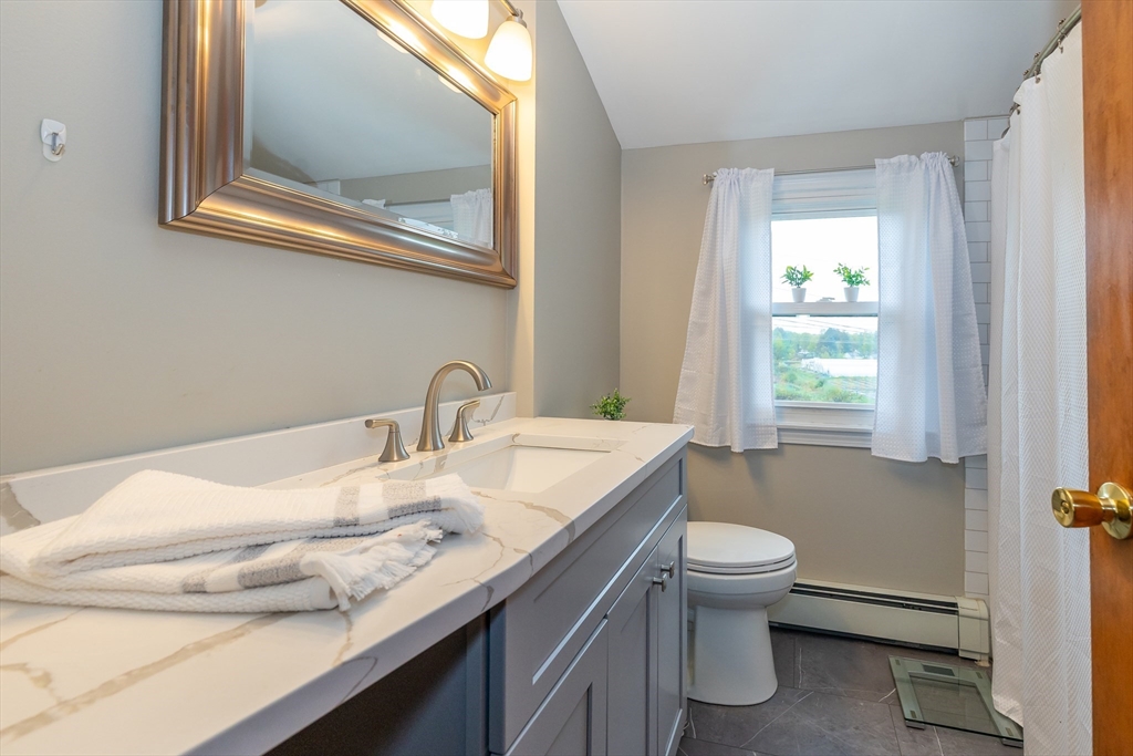 7 Adirondack Road Chelmsford, MA 01824 - Photo 15 of 31 a bathroom with a granite countertop sink toilet and a mirror