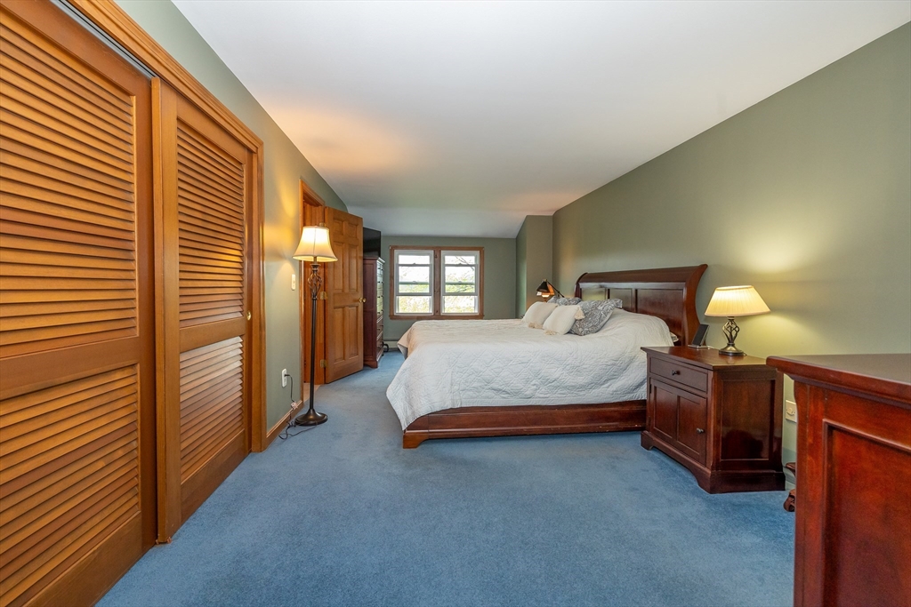 7 Adirondack Road Chelmsford, MA 01824 - Photo 18 of 31 a spacious bedroom with a bed and a lamp on the dresser