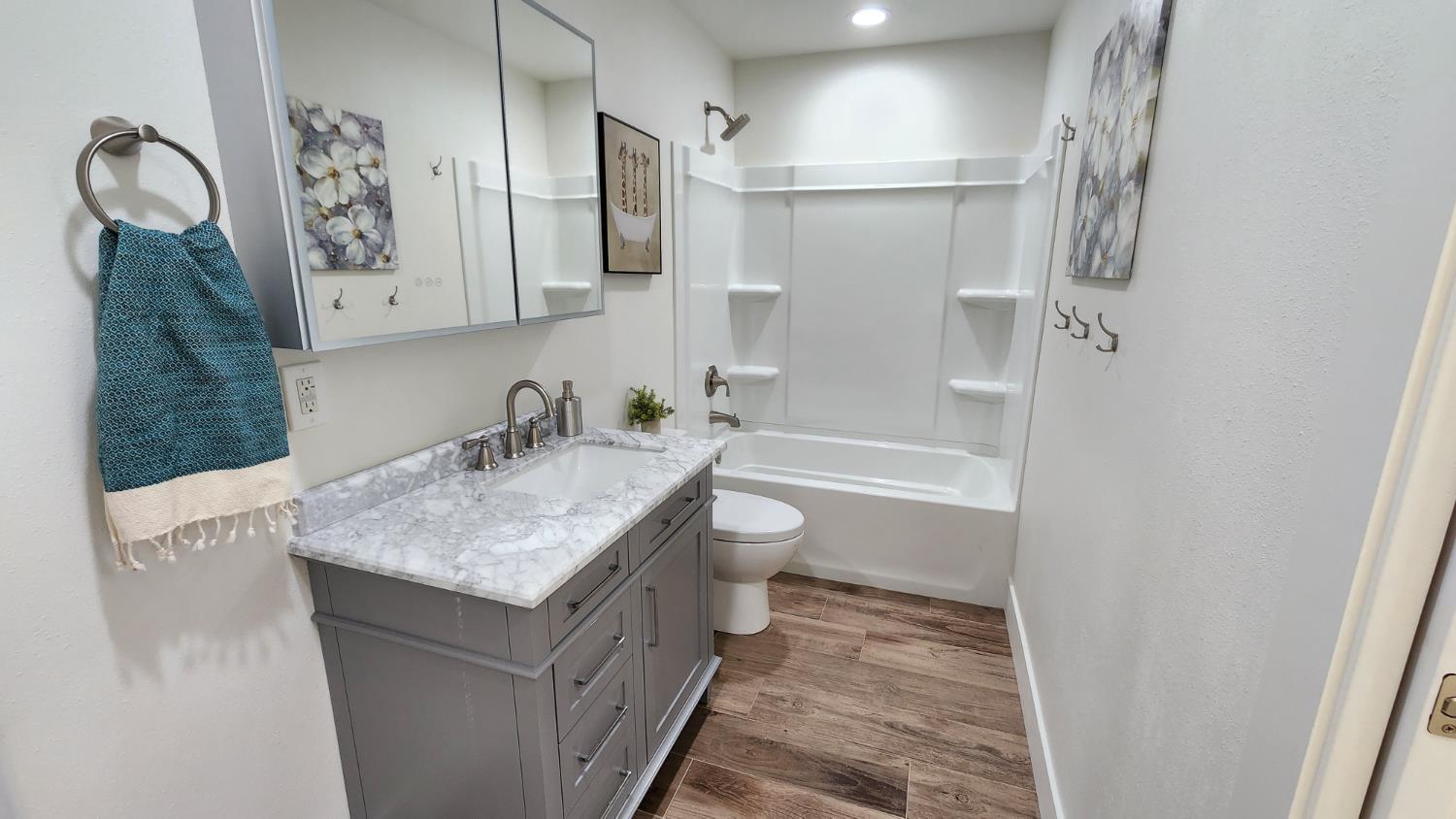 55062 Oak Crest Court Wishon, CA 93669 - Photo 31 of 57 a bathroom with a granite countertop sink a toilet and shower