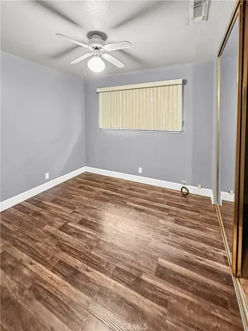 a view of a room with a ceiling fan