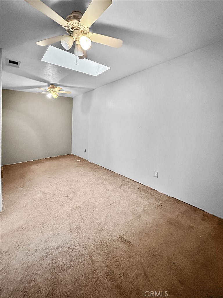 15 Regent Loop Oroville, CA 95966 - Photo 14 of 22 an empty room with a fan & a ceiling fan