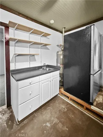 a kitchen with a refrigerator a stove and cabinets