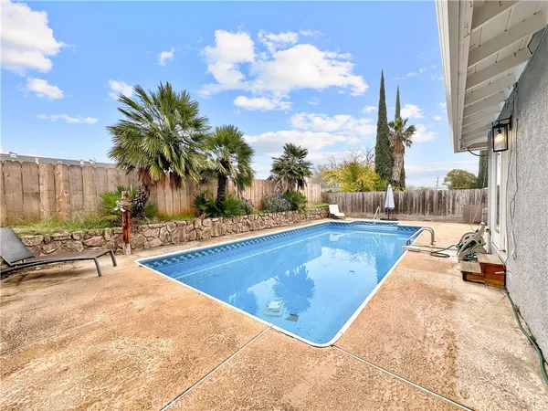 a view of swimming pool with chairs