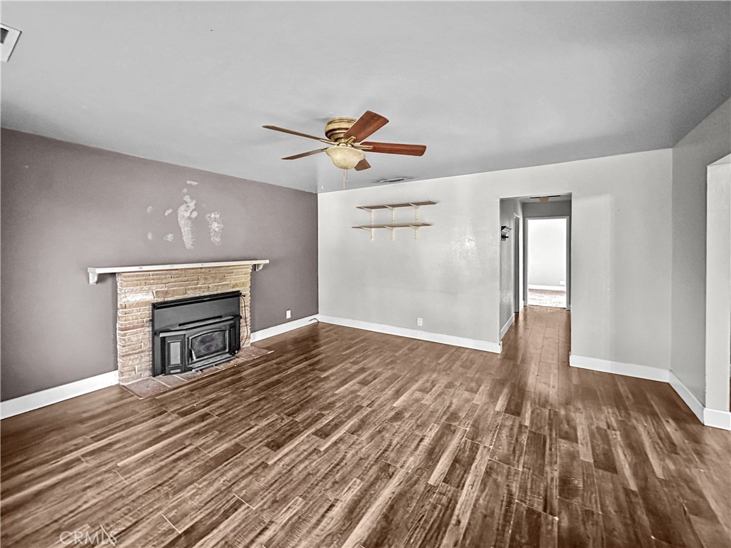 15 Regent Loop Oroville, CA 95966 - Photo 4 of 22 a view of empty room with wooden floor and fireplace