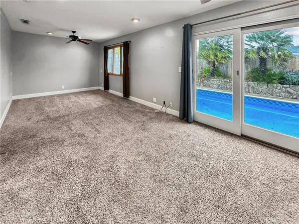 an empty room with sliding door and wooden floor