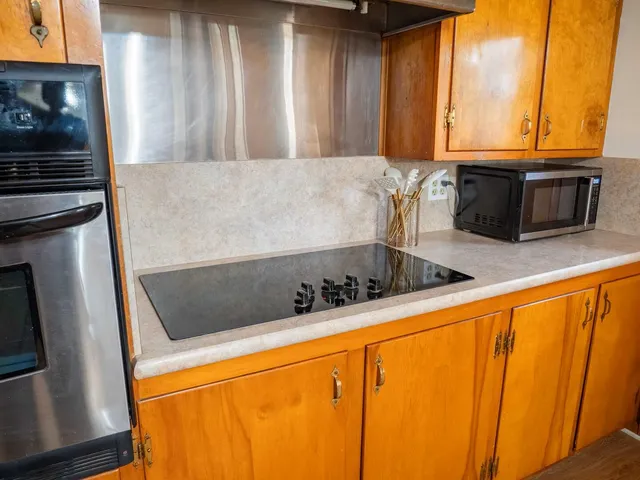 a kitchen with stainless steel appliances a stove a microwave and a refrigerator