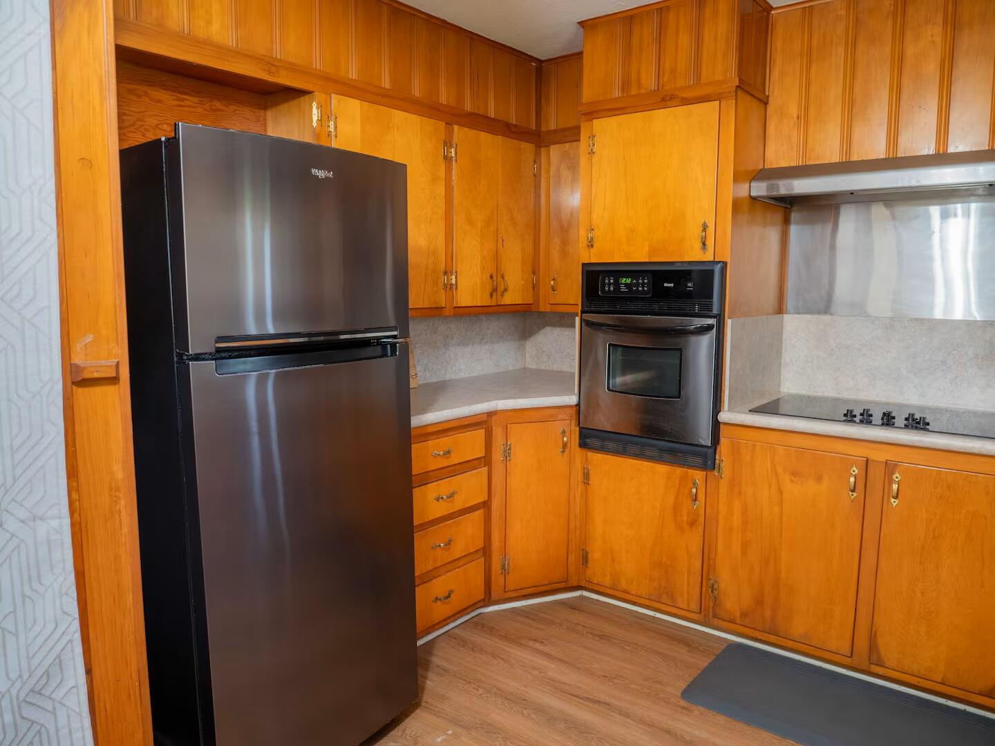 3506 46th Street Lubbock, TX 79413 - Photo 12 of 27 a kitchen with stainless steel appliances granite countertop a refrigerator and a stove top oven