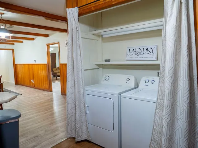 a view of washer and dryer with wooden floor