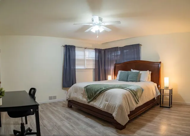 a bedroom with a bed and a chandelier