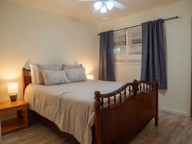 a bed sitting in a bedroom next to a window