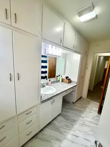 a large bathroom with a double vanity sink and mirror